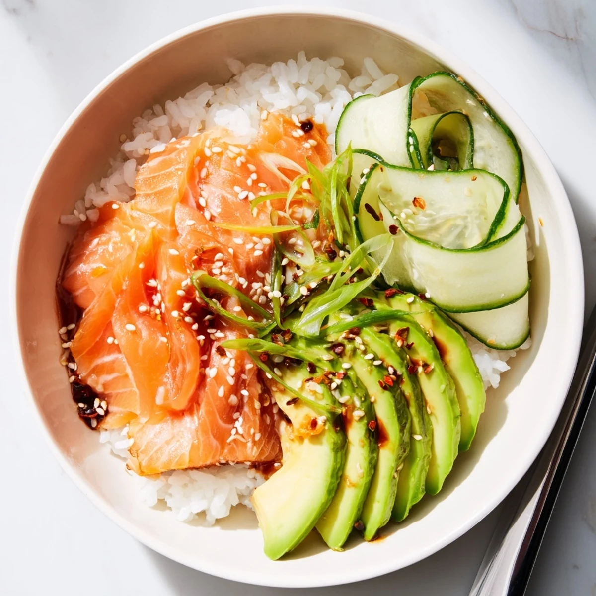 Flaky leftover salmon & rice bowl topped with fresh veggies and sesame seeds.  