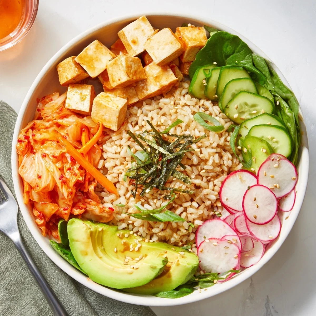 Healthy fermented vegetable bowl featuring crunchy carrots, kimchi, and sesame seeds on top.