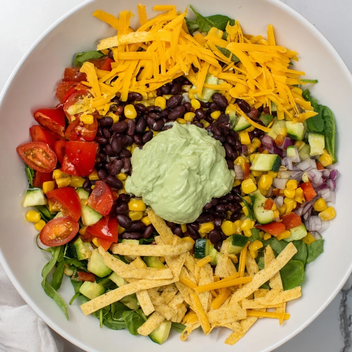 Steaming Veggie-Packed Taco Skillet with Avocado Yogurt topped with fresh cilantro and a lime wedge.