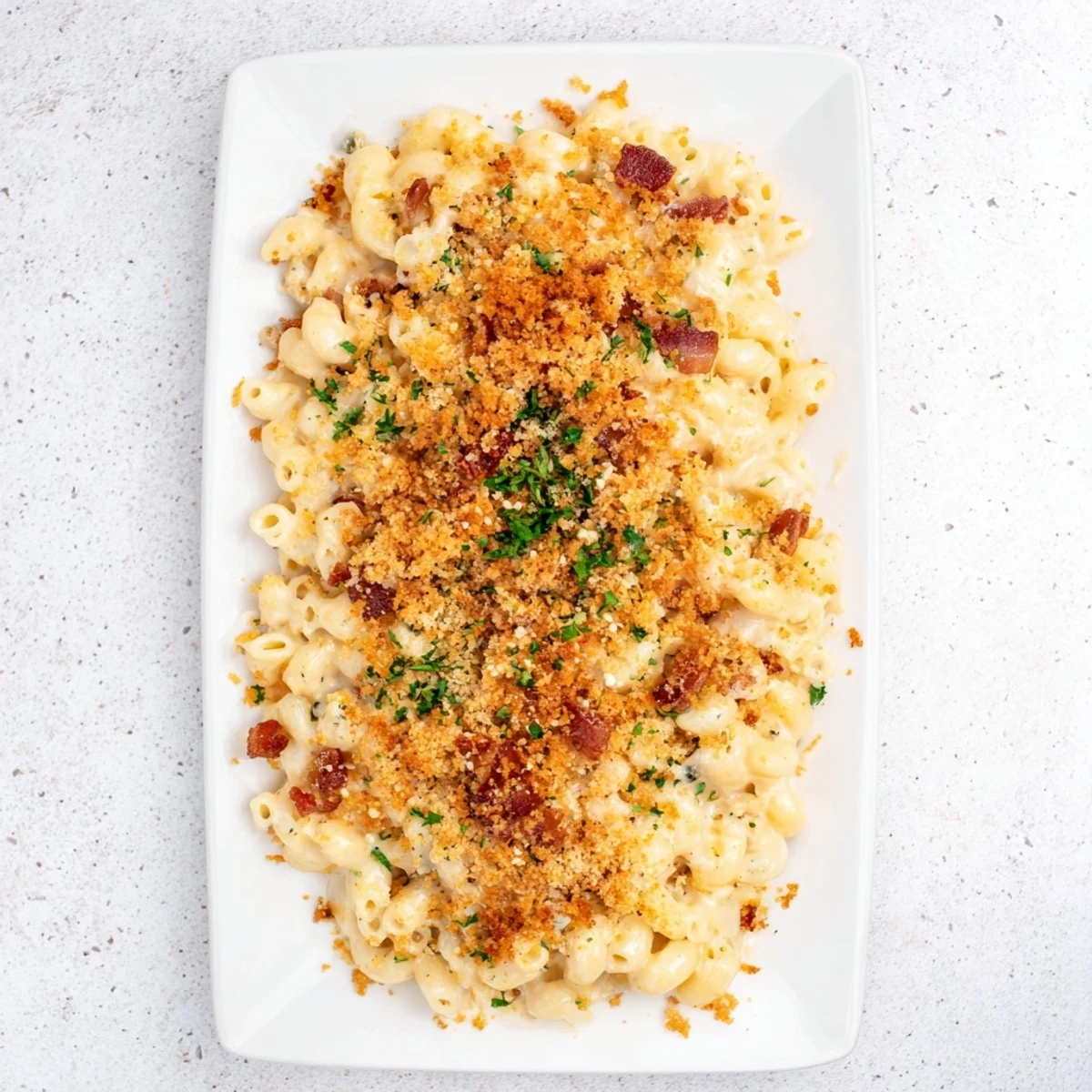 This sheet pan mac and cheese has a savory bacon crumble topping, perfect for a cozy meal.