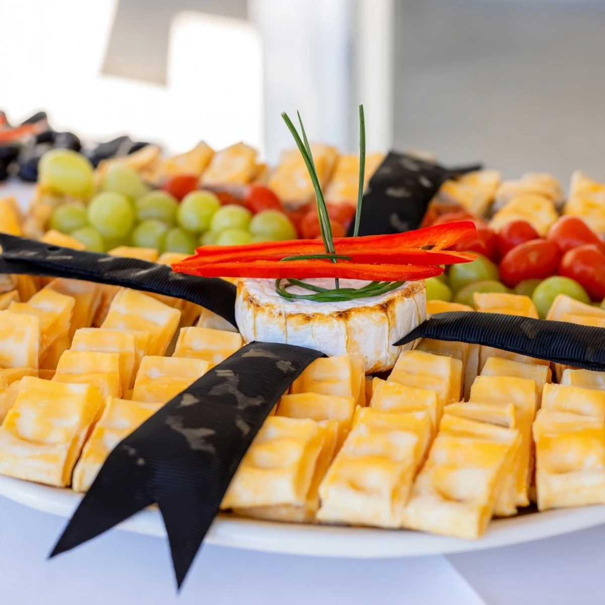 Delicious Graduation Cap Platter: a festive appetizer boasting vibrant veggies and cheeses ready to serve.