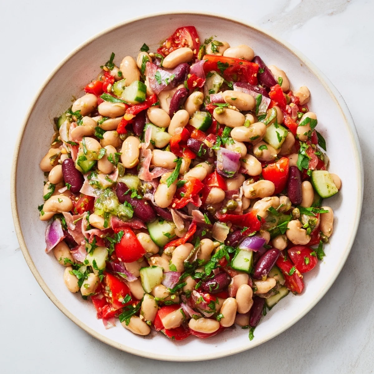 Close-up of a vibrant dense bean salad with prosciutto, perfect for a light, delicious lunch.