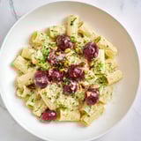 A close-up shot of the finished pasta with roasted grapes; vibrant and enticing flavors.