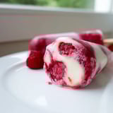 Frozen raspberry coconut ice pops, a sweet vegan treat with creamy coconut and berry layers.