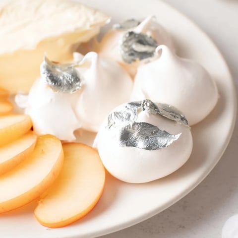 Pearly Gates cheese board, featuring creamy brie and delicate white peaches, ready to be enjoyed.