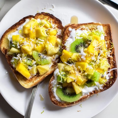 Golden-baked yogurt-custard toast drizzled with honey and vibrant fruity toppings.  