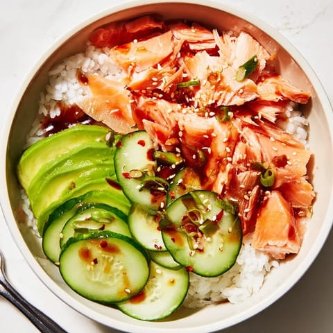 Delicious leftover salmon & rice bowl, drizzled with soy sauce and avocado slices.  