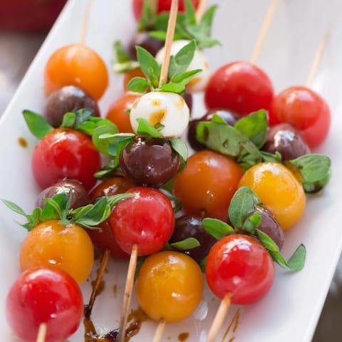 Festive Christmas Lights Olive and Tomato Skewers: a close-up of colorful cherry tomatoes and olives skewered.