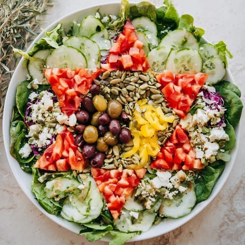 Colorful Star of David Salad Platter with tomatoes, peppers, olives, ready to serve this Hanukkah.