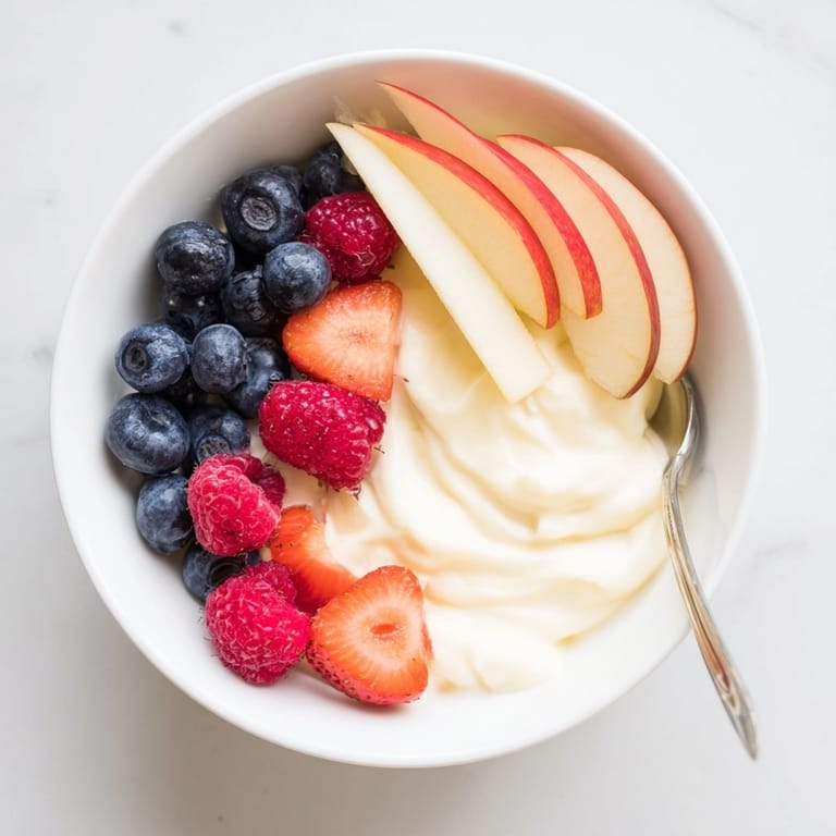 Easy Greek Yogurt Fruit Dip served in a bowl, accompanied by sliced apples and pretzel sticks.