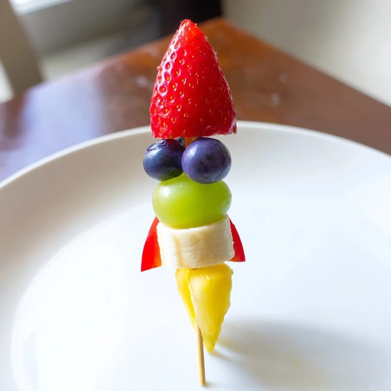 Cool, refreshing Rocket Ship Fruit Skewers are a kid-friendly treat, featuring juicy fruit pieces on skewers.