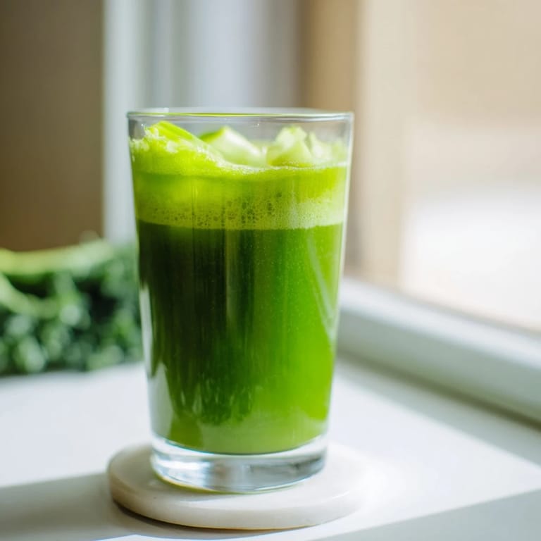 Cabbage and Kale Detox Juice in a clear mason jar, garnished with fresh kale leaves and a slice of crisp green apple.