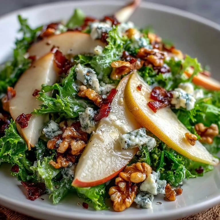Close-up of Frisée Pear Blue Cheese Bowl with crumbled blue cheese, toasted walnuts, and zesty vinaigrette.